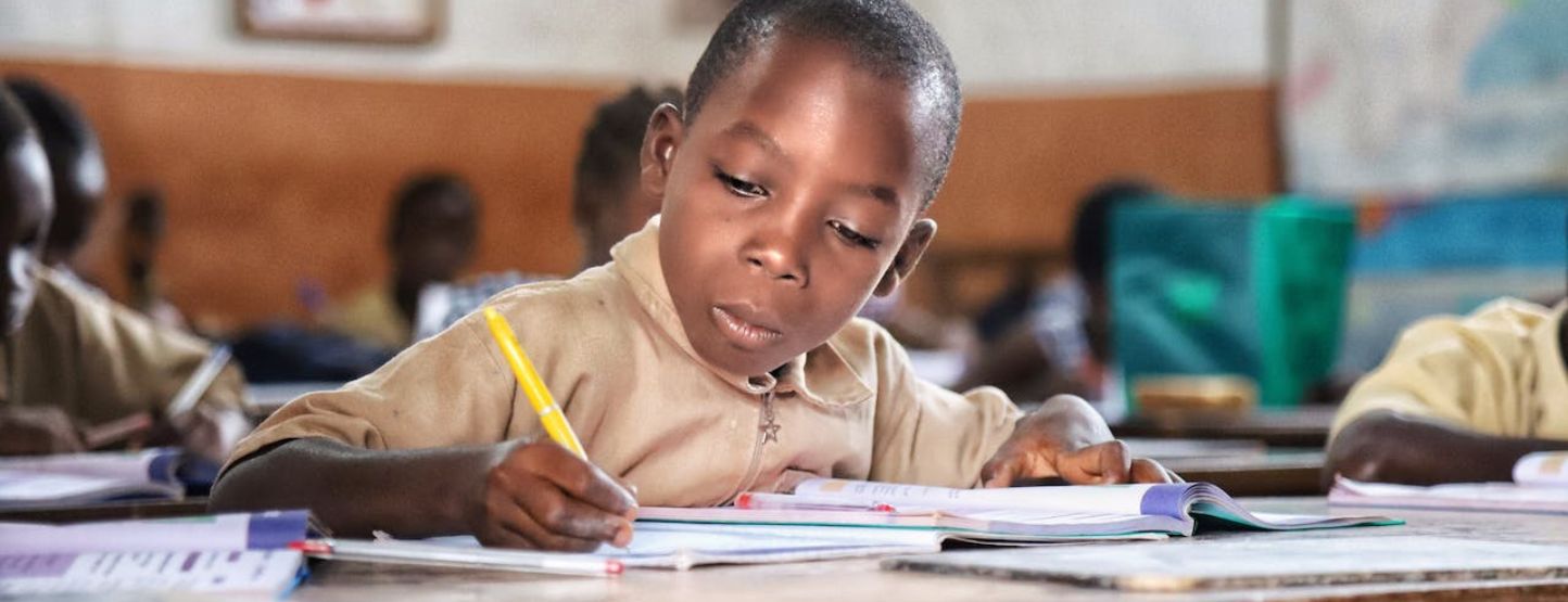 Photo by Michele Ferrari: https://www.pexels.com/photo/boy-in-brown-shirt-writing-on-white-paper-4587189/